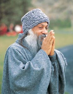 Image of osho praying with nature in the background.